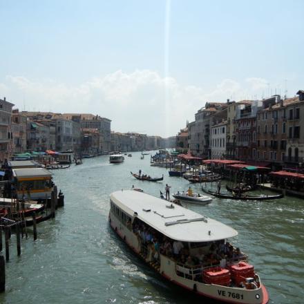 Explore Venice's Grand Canal with boats and historic buildings along the water.